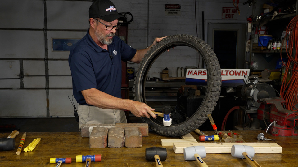 demonstrating how to to use the mallet with motorcycle tires
